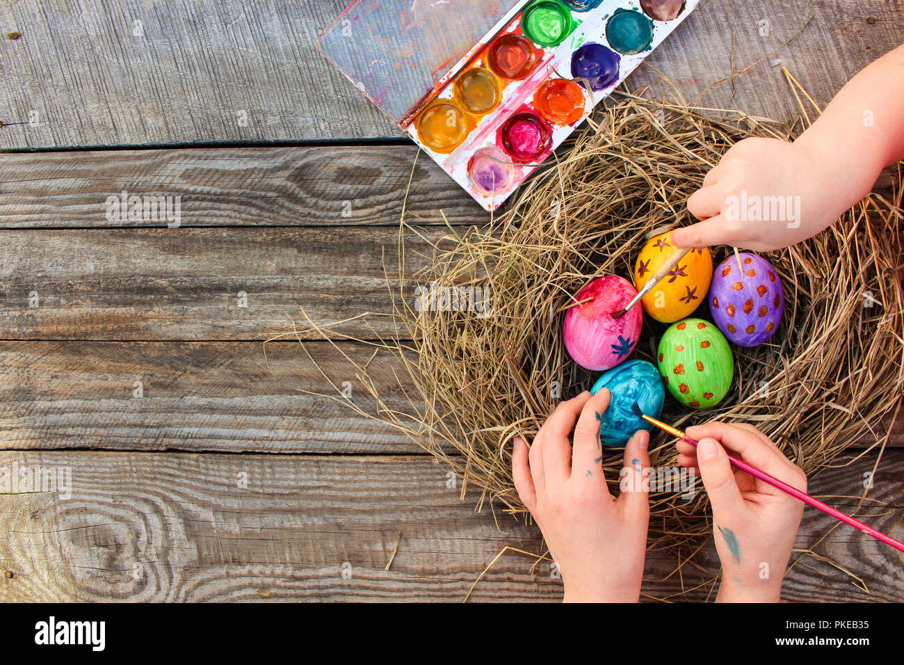 Children paints Easter eggs. Stock Photo