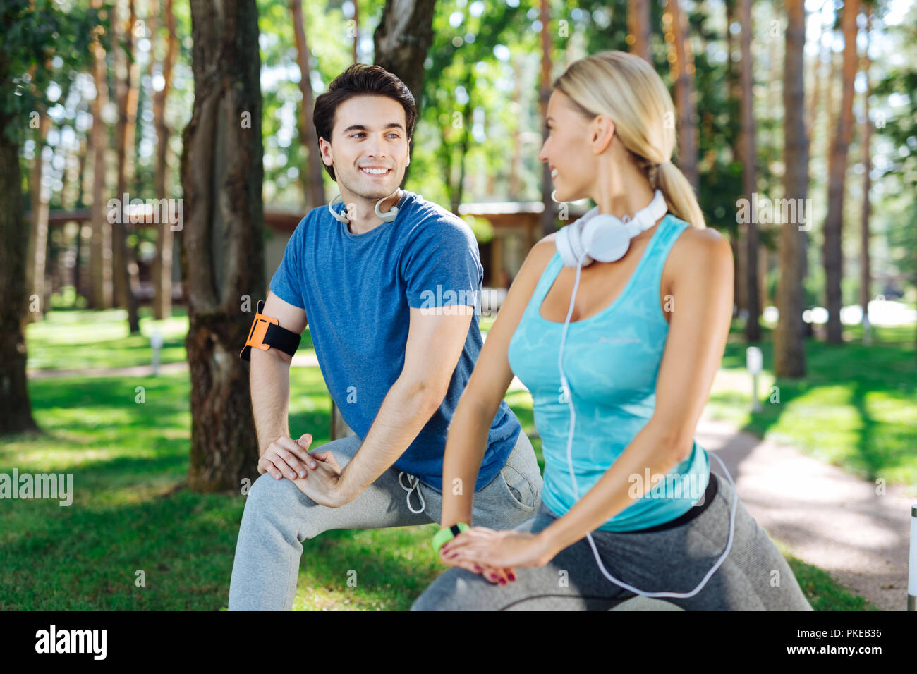 Nice pleasant man exercising with his girlfriend Stock Photo