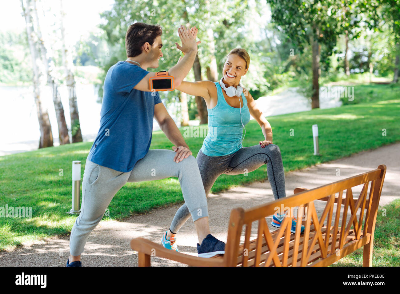 Delighted happy young people doing sports together Stock Photo