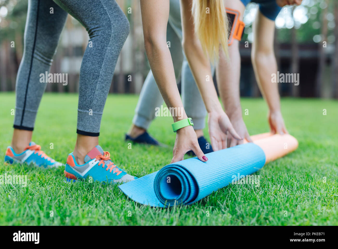 Close Up Of Yoga Mats Being Put On The Grass Stock Photo