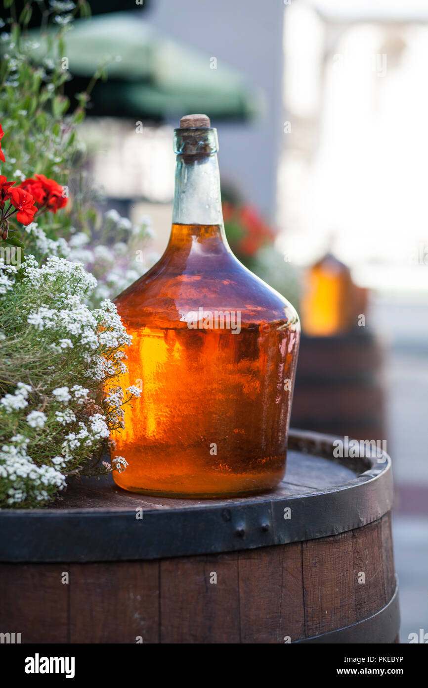 Large bottle of homemade wine are on the barrel. Vintage large wine bottle Stock Photo Alamy