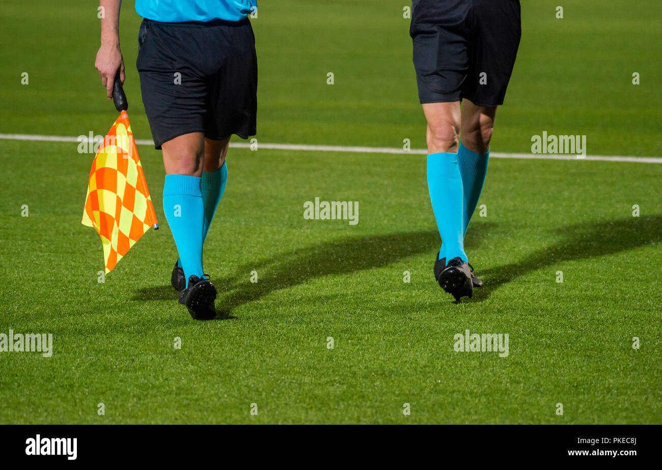 Assistant referee walking along the sideline during a soccer match Stock Photo Alamy