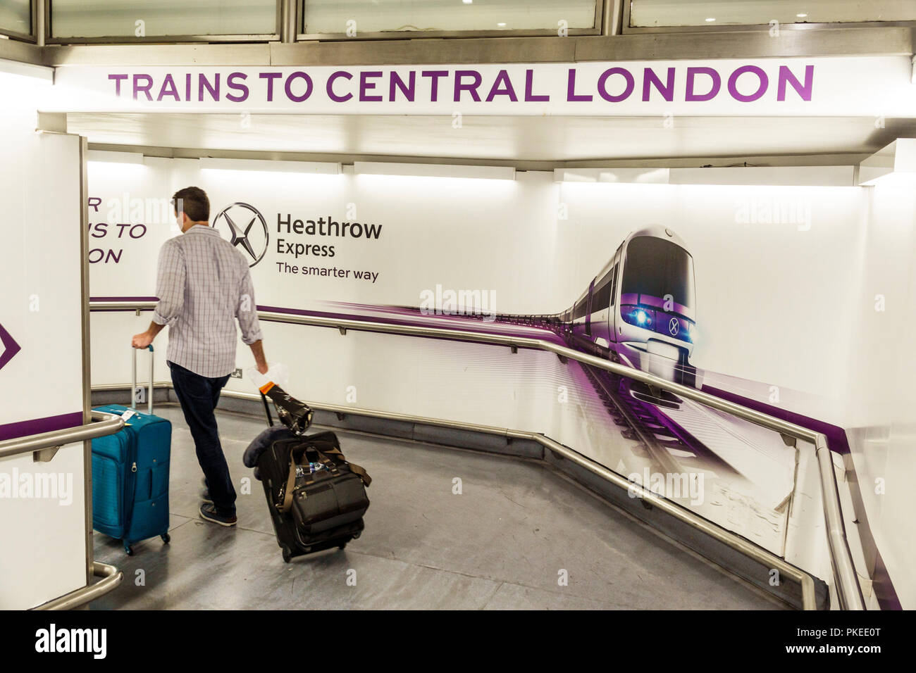 London England,UK,Heathrow Airport LHR,ground transportation,trains,man men male,pulling rolling luggage,UK GB English Europe,UK180814012 Stock Photo