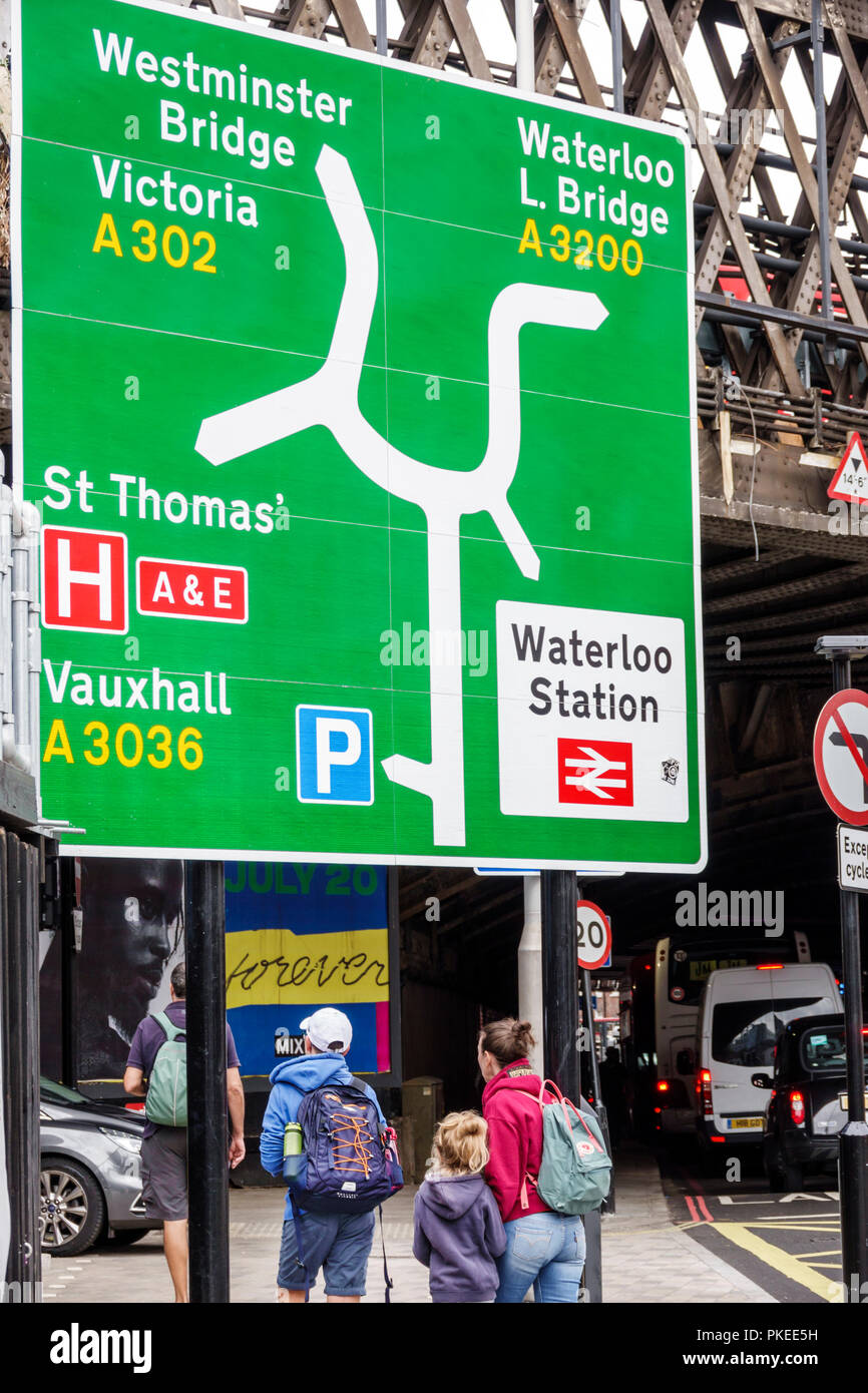 London England,UK,South Bank,Lambeth,road traffic sign,directional directions,Westminster Bridge,Waterloo train rail station,pedestrian,woman female w Stock Photo