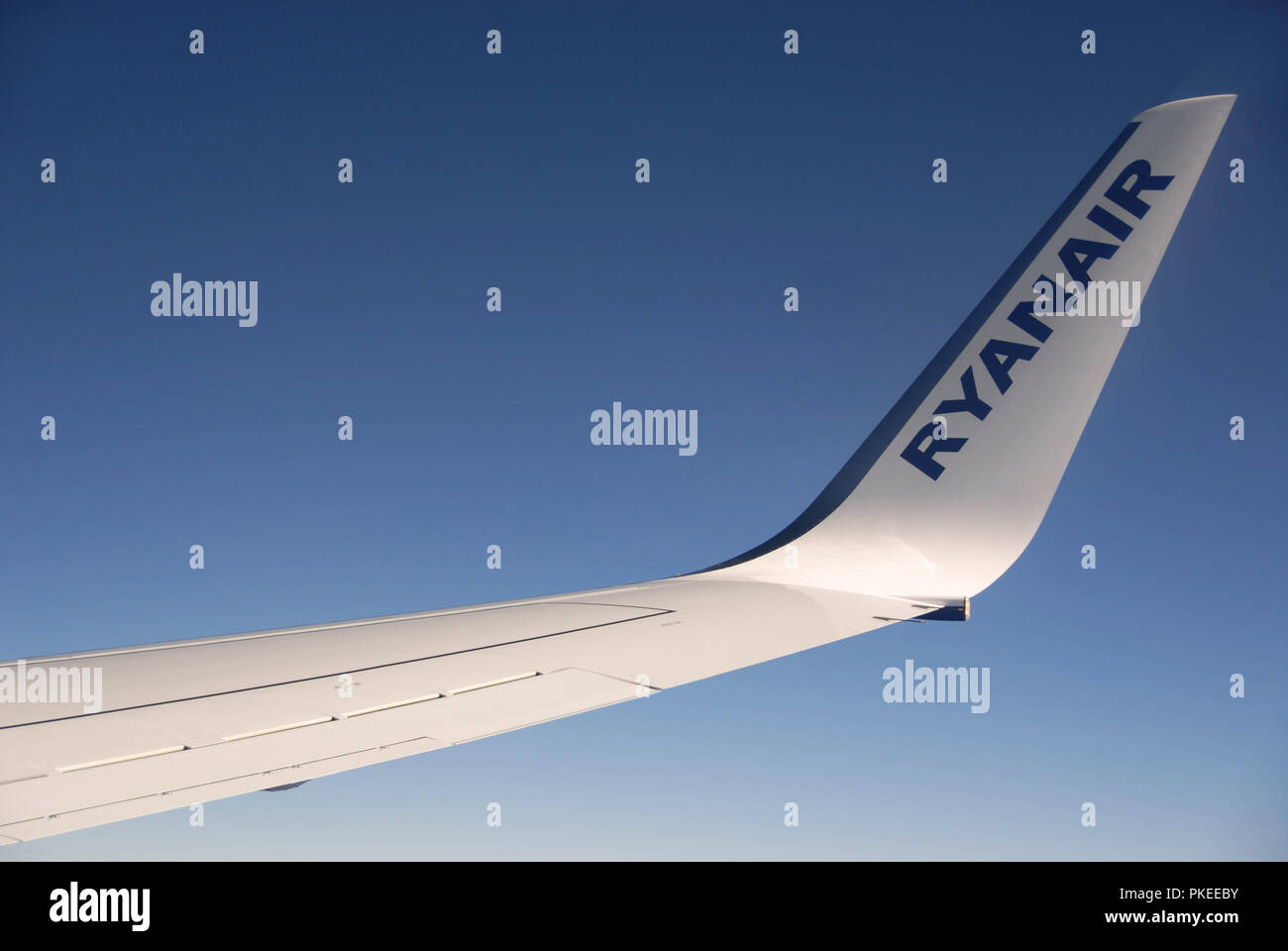 view of a Ryanair Boeing 737 800 wing out of plane window in flight