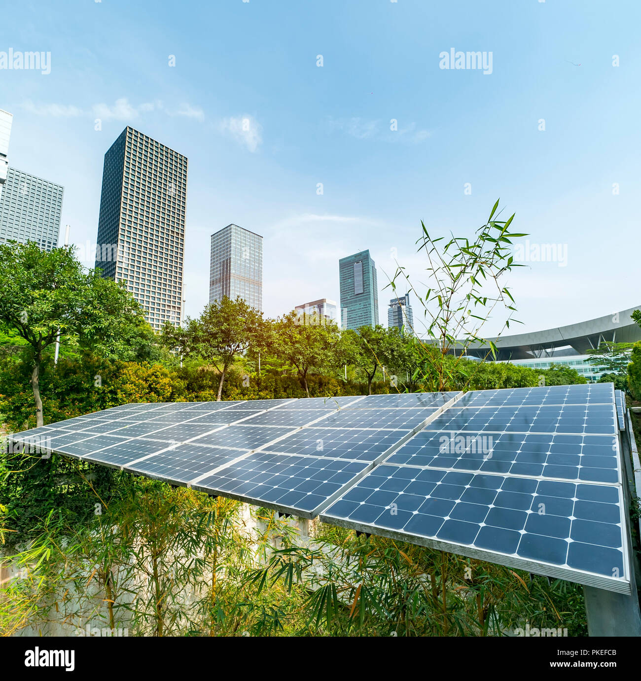 Ecological energy renewable solar panel plant with urban landscape