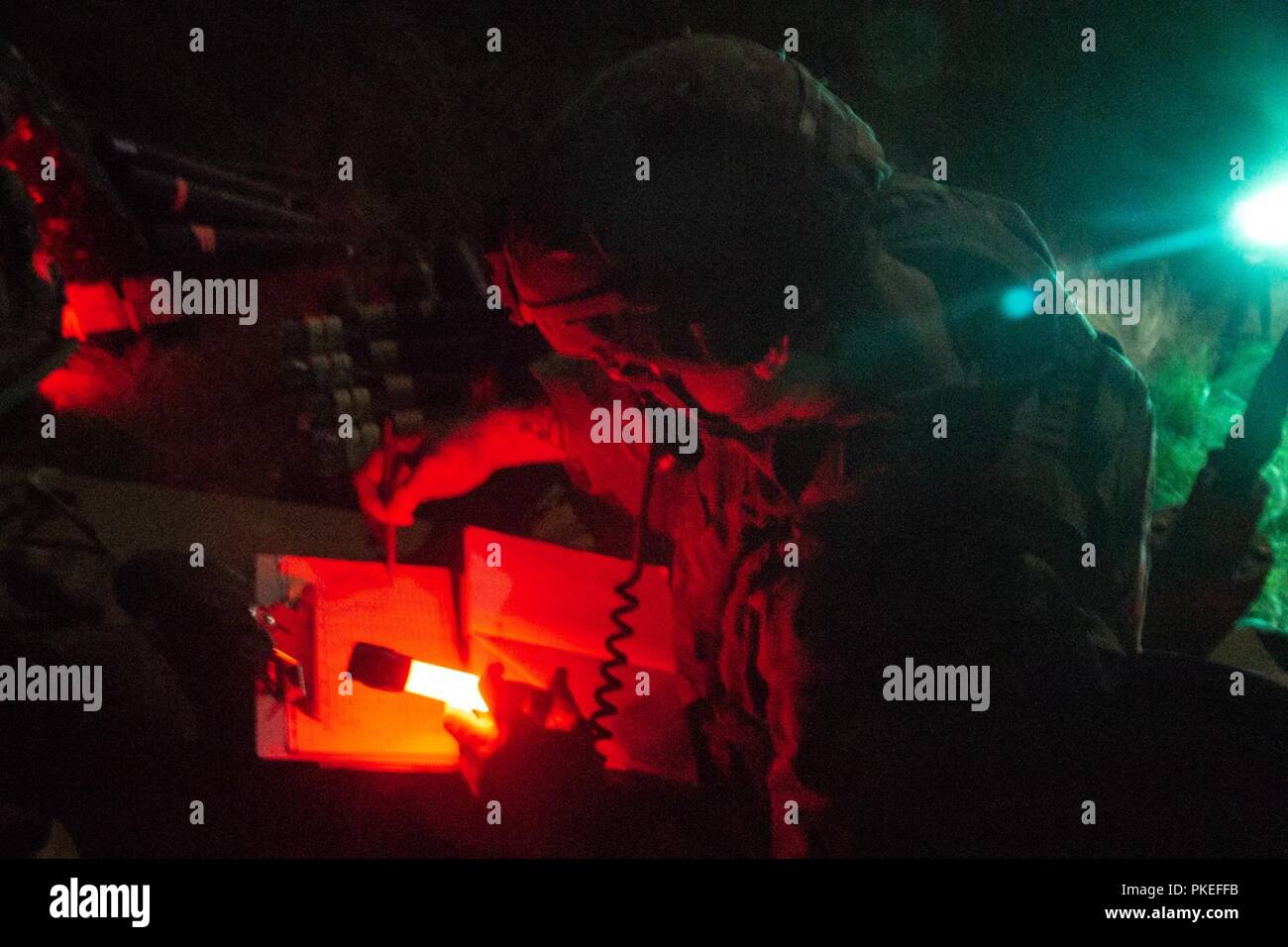 Fire Direction Center and Tank Commander Sgt. Steven Rinck of Headquarters and Headquarters Company, 2nd Battalion, 69th Armor Regiment, 2nd Armored Brigade Combat Team, communicates with Fire Support Teams by using a Joint Battle Command-Platform radio during night operations of Gunnery Tables IV, V, and VI at Fort Stewart, Ga., July 24. The mortar platoons mission is to provide close and immediate indirect fire support for battalions and companies. Stock Photo