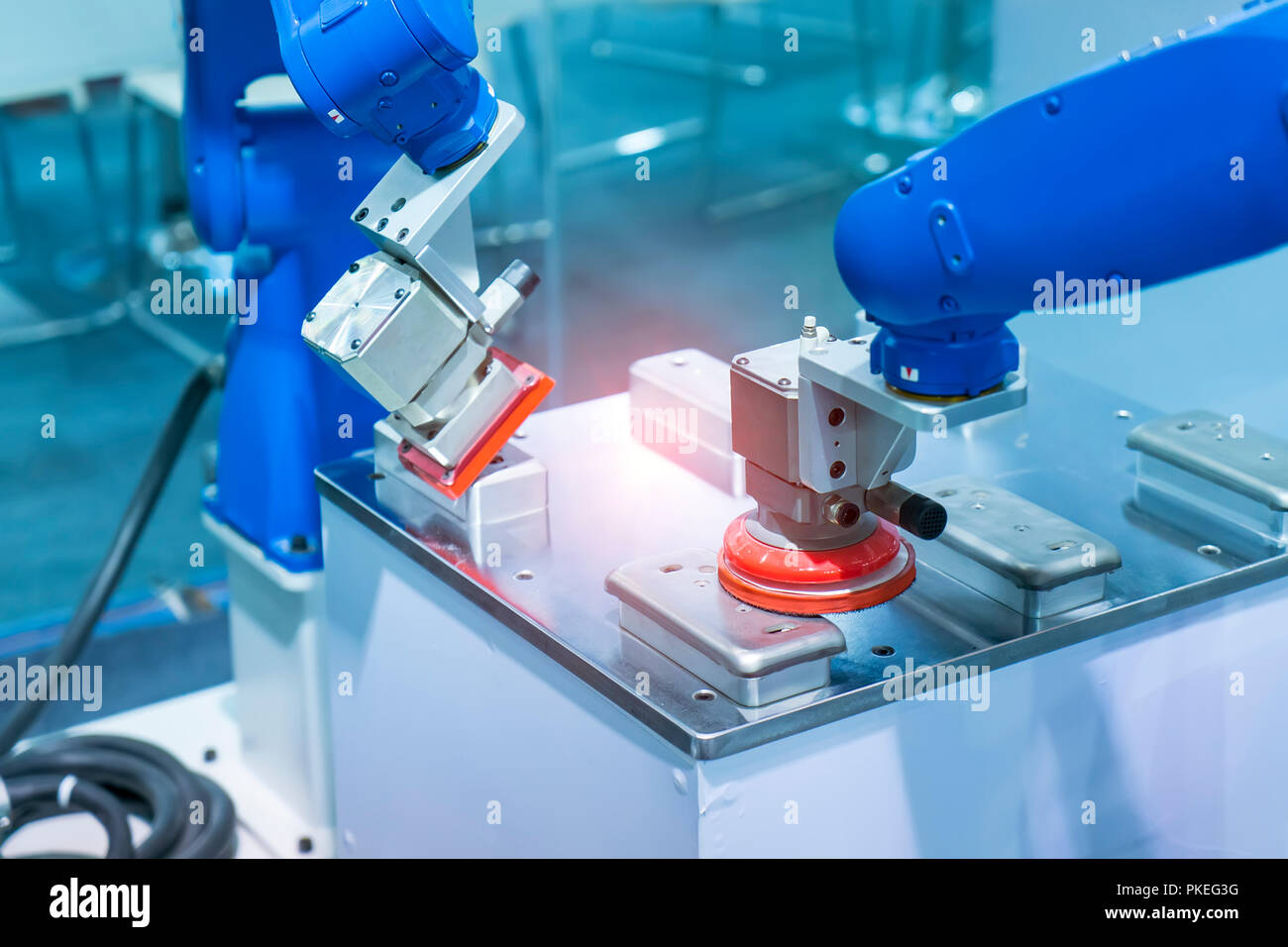 Industrial robot working in phone factory Stock Photo