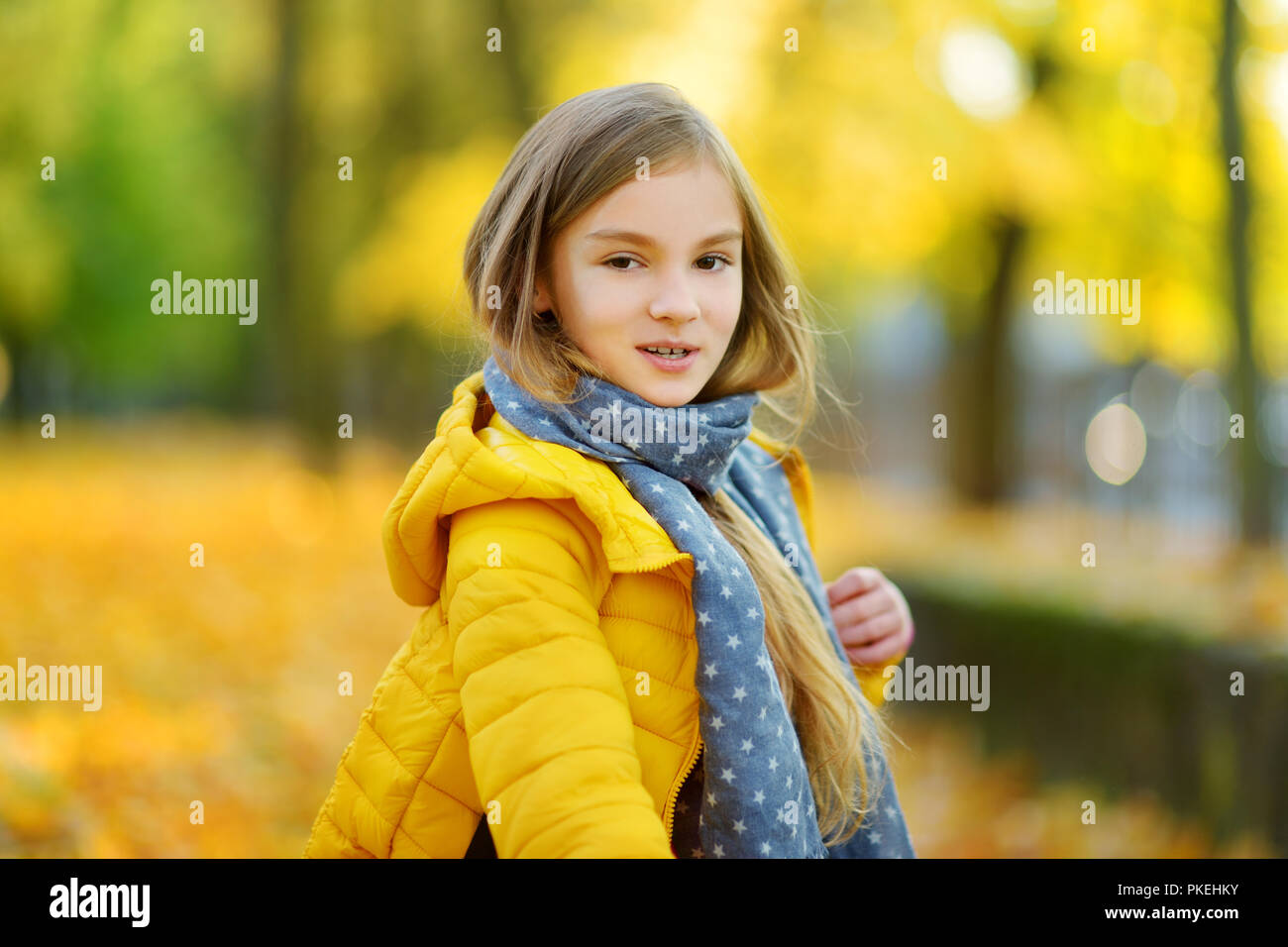 Cute little girl having fun on beautiful autumn day. Happy child ...