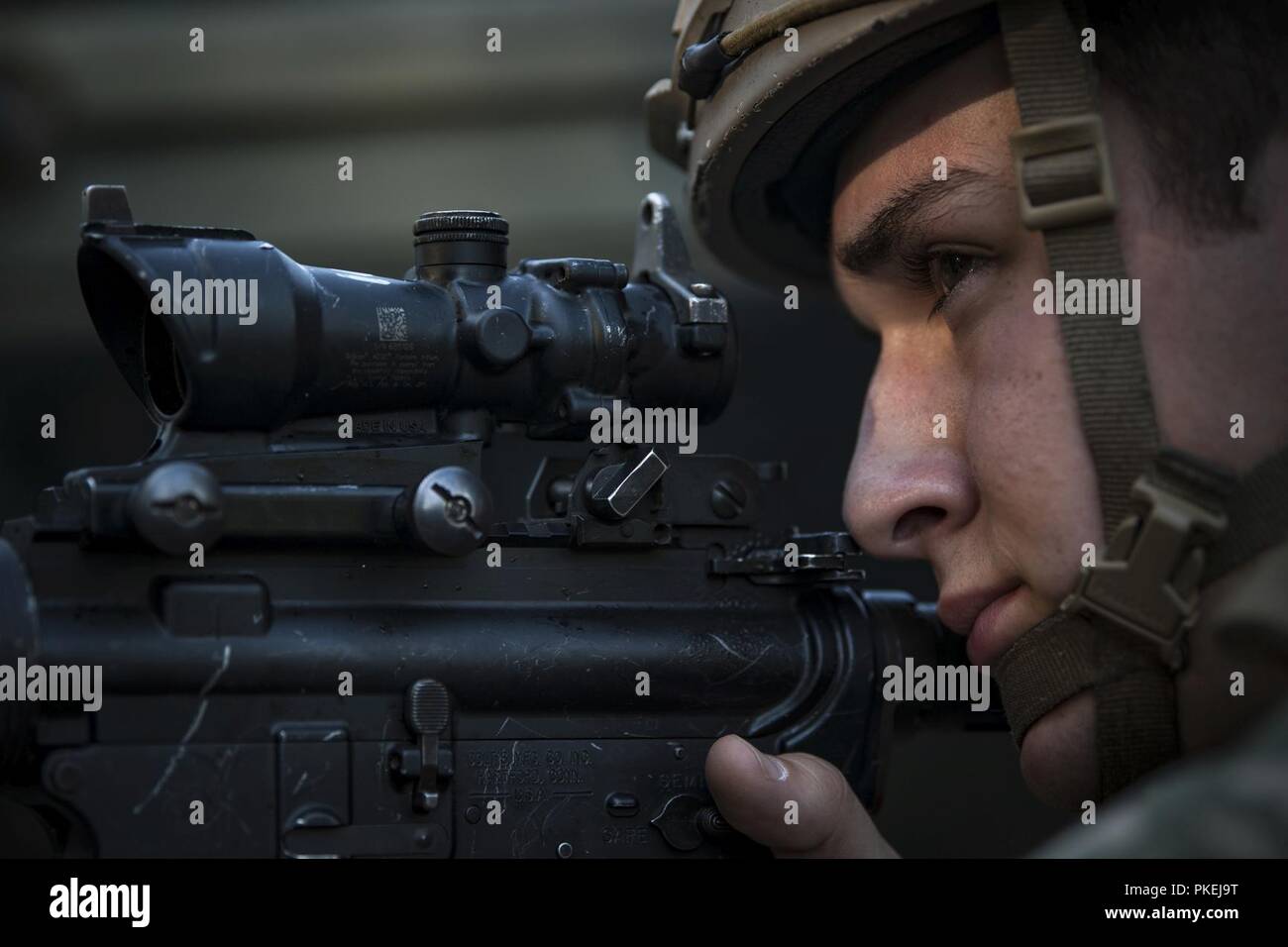An Airman from the 822d Base Defense Squadron (BDS) aims down his sights during a full mission profile assessment, July 24, 2018, at Moody Air Force Base, Ga. The ‘Safeside’ defenders evaluated their base defense tactics and procedures while performing patrols, tactical combat casualty care and countering improvised explosive devices for a mission readiness exercise. After successfully completing these events, the defenders are eligible to earn their Global Response Force status, which certifies the unit to deploy worldwide. Stock Photo