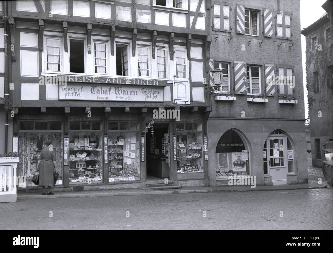 1950s, historical, an old German building in the old town in the city of  Koln, Germany. A newsagent and tobacconist shop on the ground floor can be  seen which also sells souvenirs