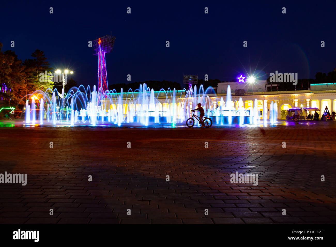 Bright colorful fountains at night on the embankment of the Amur river ...