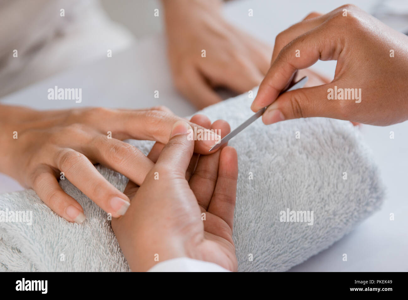 Beautician using a cuticle pusher Stock Photo Alamy