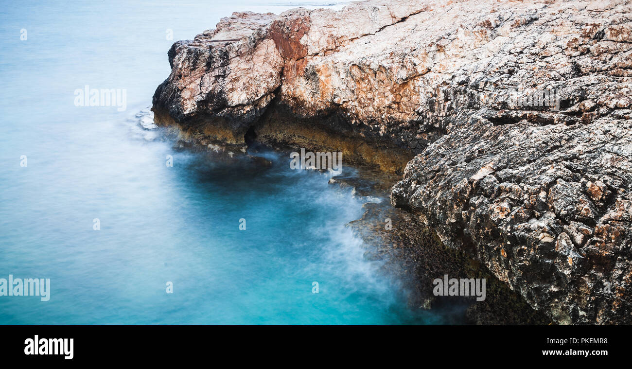 Coast of Mediterranean Sea. Long exposure photo with natural blurred water effect. Summer morning landscape of Ayia Napa, Cyprus island Stock Photo