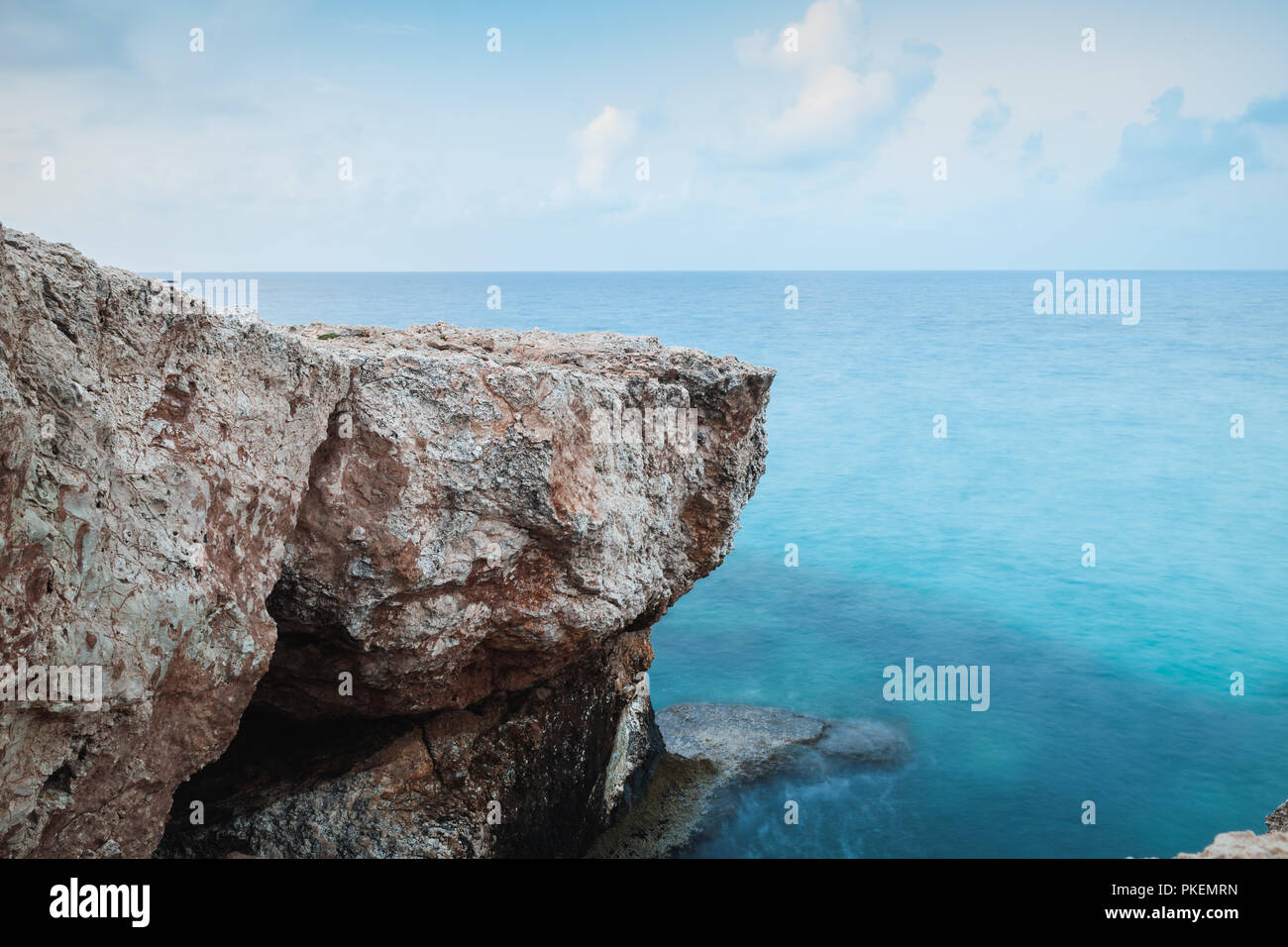 Mediterranean Sea coastal rocks. Long exposure photo with natural blurred water effect. Summer morning landscape of Ayia Napa, Cyprus island Stock Photo