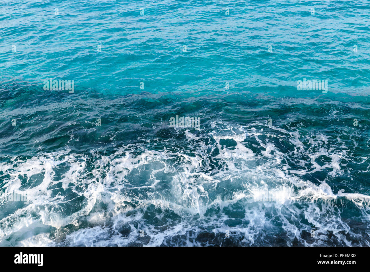 Deep blue water with shore foam, background photo taken from coast of Cyprus island, Mediterranean Sea Stock Photo