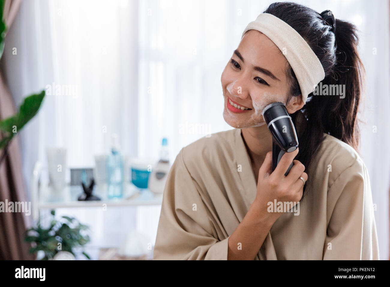woman using electric facial cleanser machine Stock Photo Alamy