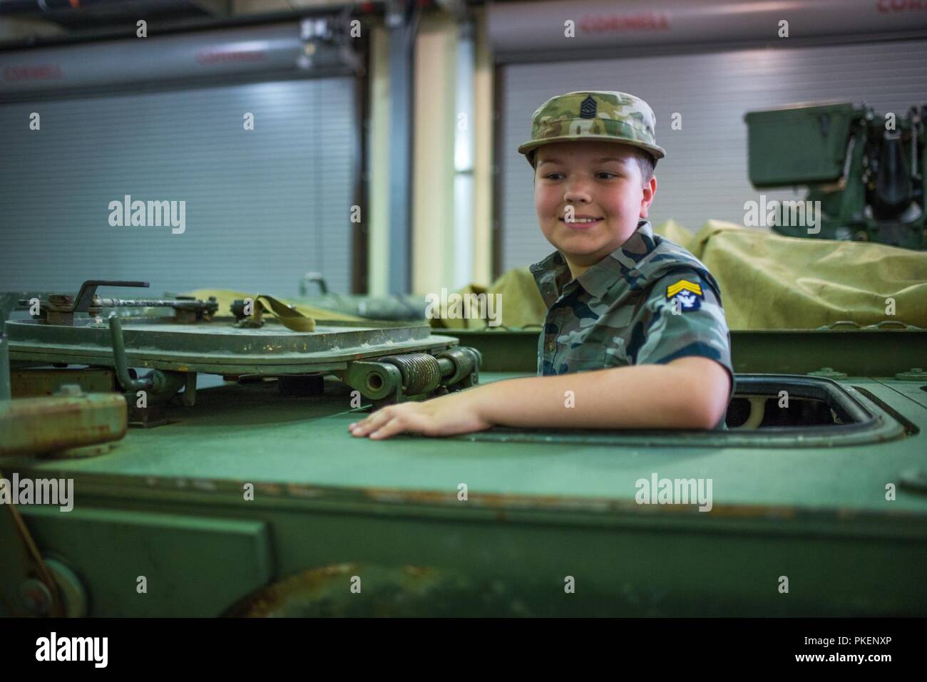 FORT BENNING, Ga. (July 30, 2018) – Nine-year-old military enthusiast Eli Wilson visited locations throughout Fort Benning, Georgia, July 26. Wilson, who has Asperger’s syndrome, ate lunch at a dining facility with Delta Company, 1st Battalion, 46th Infantry Regiment, attended a basic training graduation, visited the National Infantry Museum, and met with the 316th Cavalry Brigade to see an M1126 Stryker Combat Vehicle and an M1 Abrams Main Battle Tank. Stock Photo