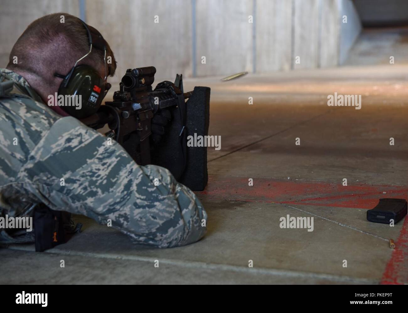 Senior Airman Nicholas Rauch, 460th Security Forces Squadron defender, sends a round into a target in preparation for the Defenders Challenge July 27, 2018, on Buckley Air Force Base, Colorado. Defenders were judged on their accuracy with the M-9 Beretta and M16 rifle during a Defenders Challenge event. Stock Photo