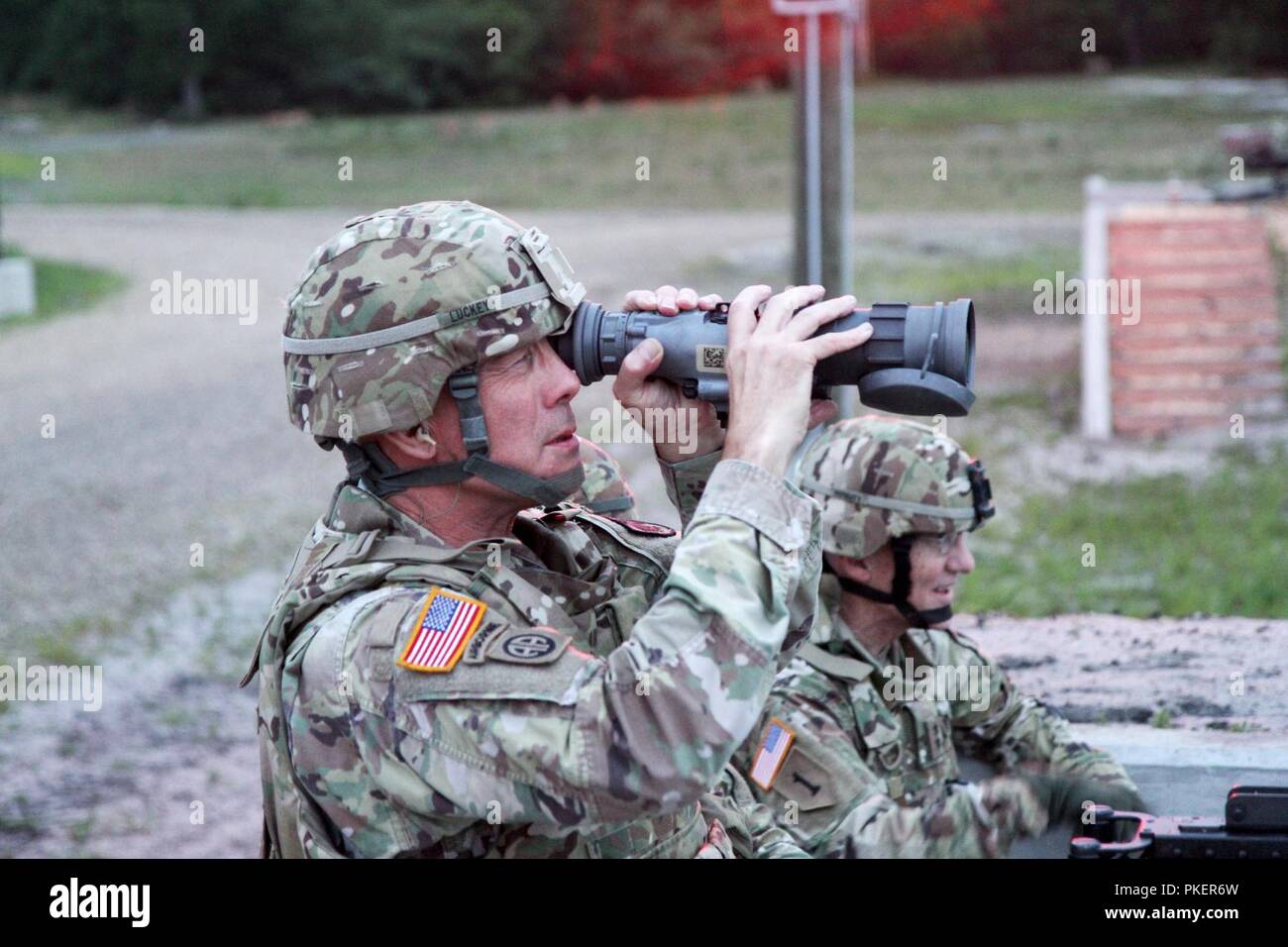 LTG Charles D. Luckey, Chief of Army Reserve and Commanding General, U.S. Army Reserve Command, looks through an AN/PAS-13 Thermal Weapon Sight, as Maj. Gen. A. Ray Royalty, commanding general, 84th Training Command, watches the lane during Task Force Ultimate, Operation Cold Steel II, hosted by U.S. Army Civil Affairs and Psychological Operation Command (Airborne) at Joint Base McGuire-Dix-Lakehurst, N.J., July 25, 2018. Operation Cold Steel is the U.S. Army Reserve’s crew-served weapons qualification and validation exercise to ensure that America’s Army Reserve units and Soldiers are trained Stock Photo