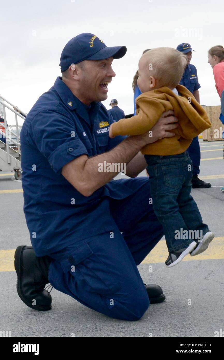 Chief Petty Officer James Maida, a boatswains mate aboard the Coast Guard Cutter Alex Haley (WMEC 39), hugs his son after the cutter moored at its homeport in Kodiak, Alaska, August 1, 2018. The crew members of the Alex Haley returned from a 90-day deployment patrolling more than 16,000 miles throughout the Pacific Ocean. U.S. Coast Guard Stock Photo