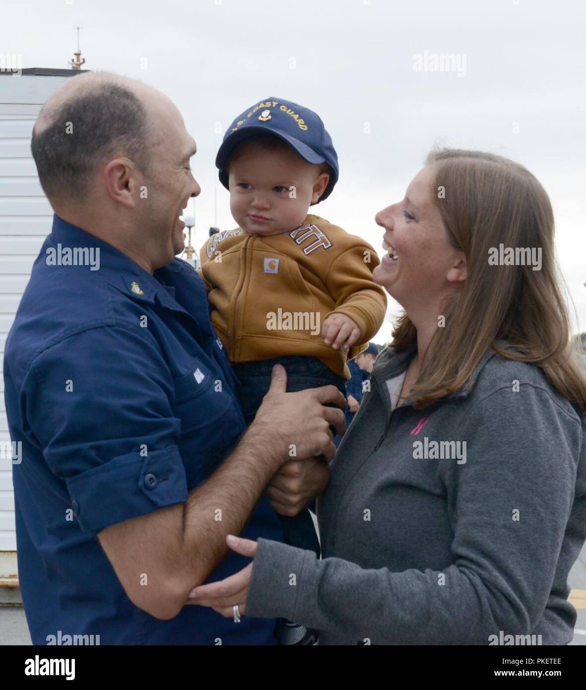 Chief Petty Officer James Maida, a boatswains mate aboard the Coast Guard Cutter Alex Haley (WMEC 39), greets his family after the cutter moored at its homeport in Kodiak, Alaska, August 1, 2018. The crew members of the Alex Haley returned from a 90-day deployment patrolling more than 16,000 miles throughout the Pacific Ocean. U.S. Coast Guard Stock Photo
