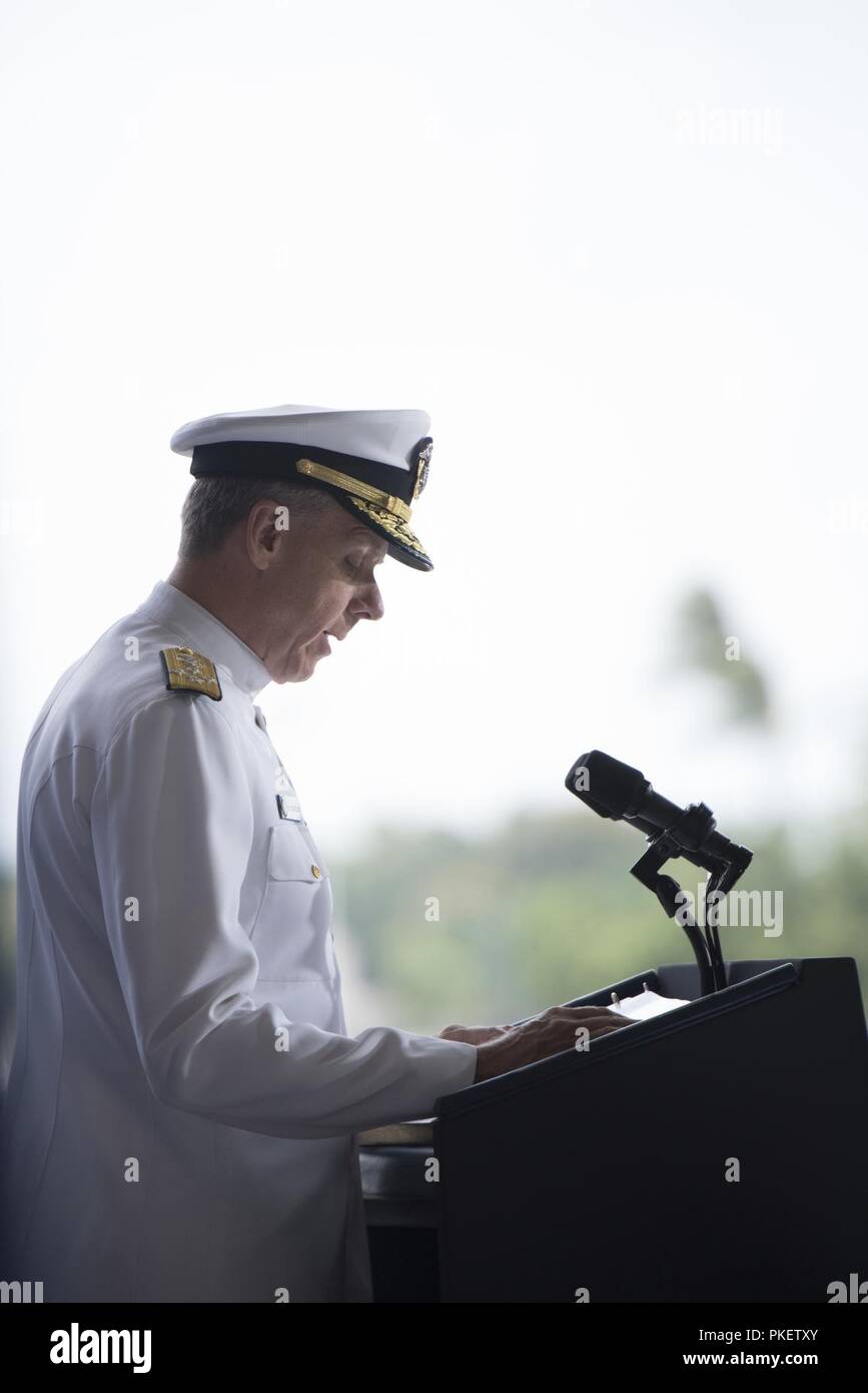 U.S. Navy Adm. Phil Davidson, U.S. Indo-Pacific Command commander, delivers his remarks during an honorable carry ceremony at Joint Base Pearl Harbor-Hickam, Hawaii, Aug. 1, 2018. The ceremony marked the arrival of 55 transfer cases recently repatriated from North Korea. The Defense POW/MIA Accounting Agency will receive the remains to start the identification process. Stock Photo