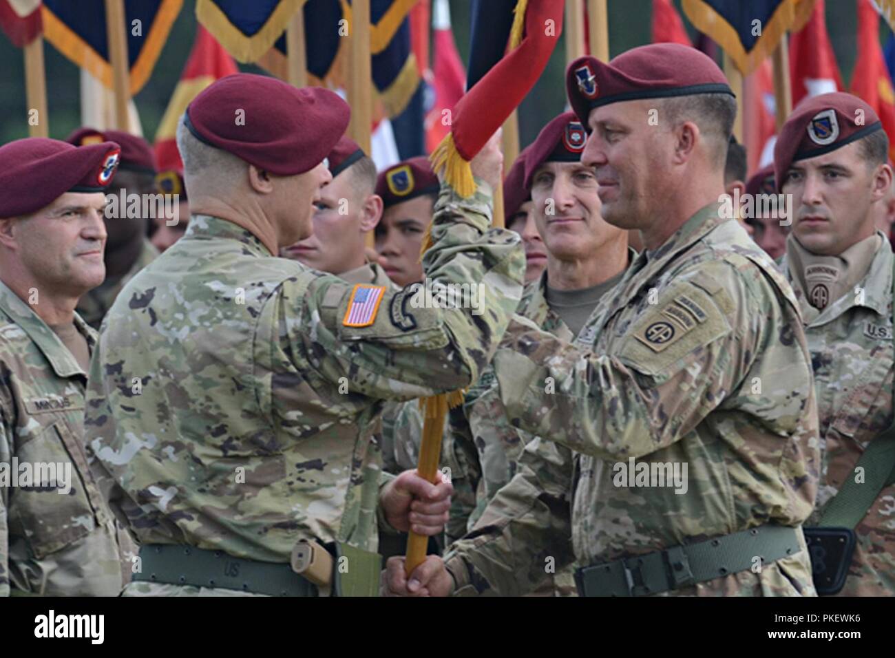 U.S. Army Maj. Gen. Michael E. Kurilla, the 82nd Airborne Division outgoing commander, passes the division colors to Lt. Gen. Paul LaCamera, the 18th Airborne Corps commander, during a change of command ceremony at Pike Field on Fort Bragg, North Carolina, Aug. 2, 2018. This marks the end of Kurilla's time as the commander of America's Guard of Honor. Stock Photo