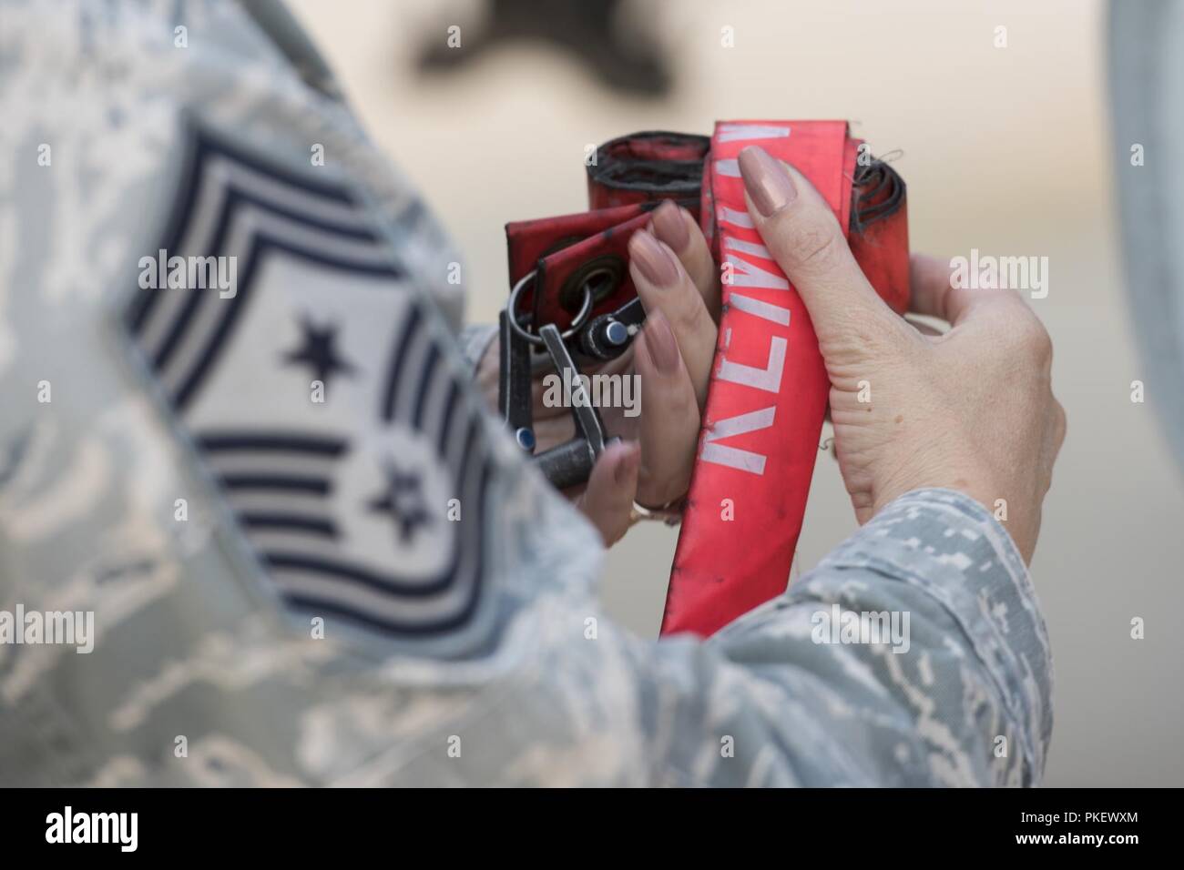 Chief Master Sgt. Tammy S. Ladley, 124th Fighter Wing command chief, wraps “remove before flight” ribbons in Boise, Idaho, Aug. 2, 2018.  As part of her retirement, Ladley assisted with the launch of an A-10 Thunderbolt II assigned to the 124th FW. Stock Photo