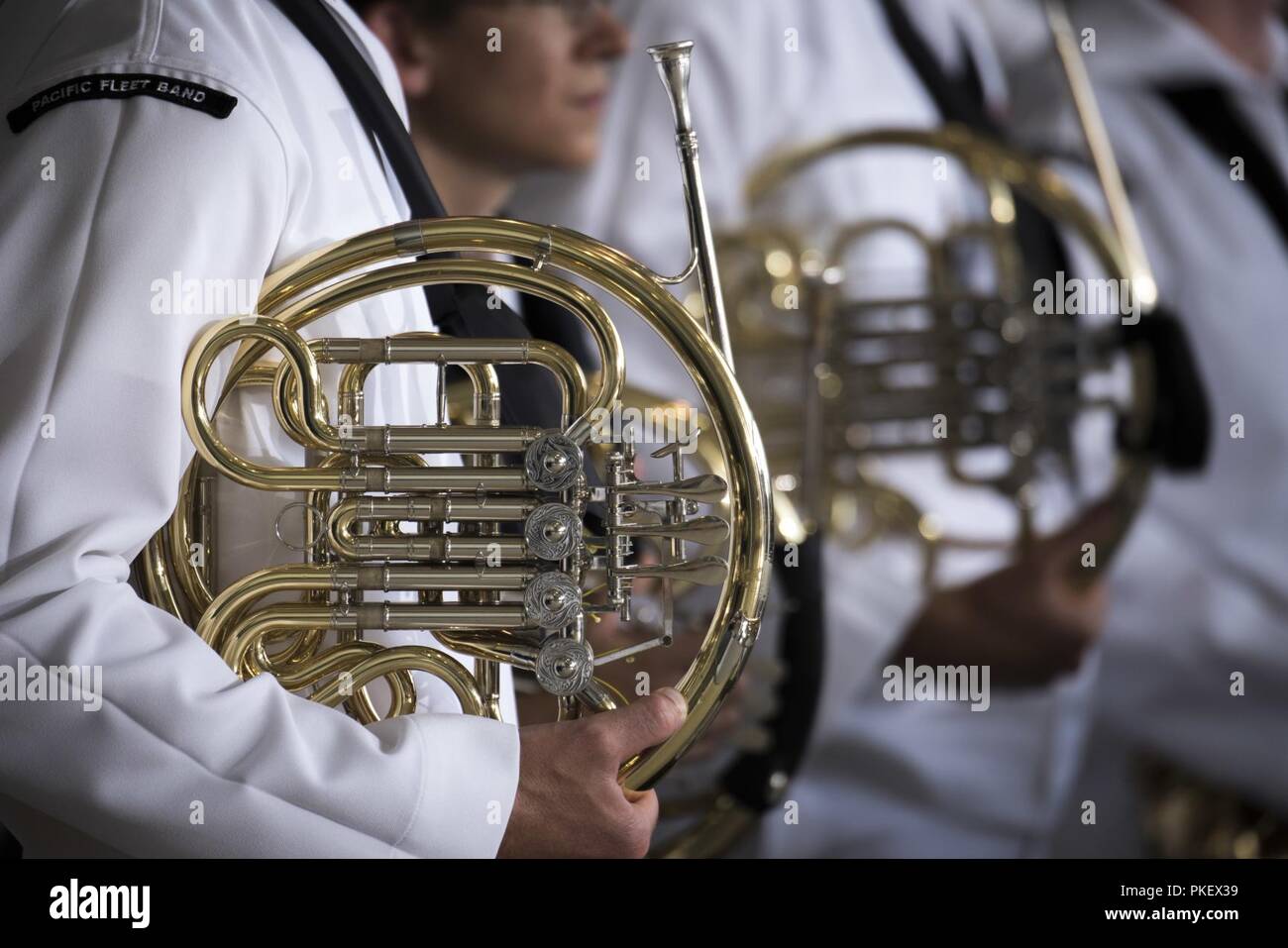 The U.S. Pacific Fleet Band plays ceremonial music during an honorable carry ceremony at  Joint Base Pearl Harbor-Hickam, Hawaii, Aug. 1, 2018. Attendees, to include Vice  President Mike Pence, U.S. Indo-Pacific Command Commander Navy Adm. Phil Davidson, Rear Dam. Jon Kreitz, Defense POW/MIA Accounting Agency deputy director, Korean War veterans and families of missing Korean and Vietnam troops, were on hand to watch the arrival of 55 flag-draped transfer cases containing what are believed to be the remains of American service members lost in the Korean War. Stock Photo