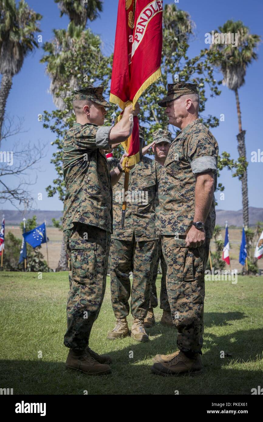 U.S. Marine Corps Col. Richard T. Anderson, left, commanding officer, Marine Corps Air Station Camp Pendleton (MCAS), holds the organizational standard during the MCAS Camp Pendleton change of command ceremony at the Santa Margarita Ranch House, Marine Corps Base Camp Pendleton, California, August 2, 2018. Anderson was the commanding officer of II Marine Expeditionary Force, Expeditionary Operations Training Group for two years before taking command of MCAS Camp Pendleton from Col. Ian R. Clark. Stock Photo