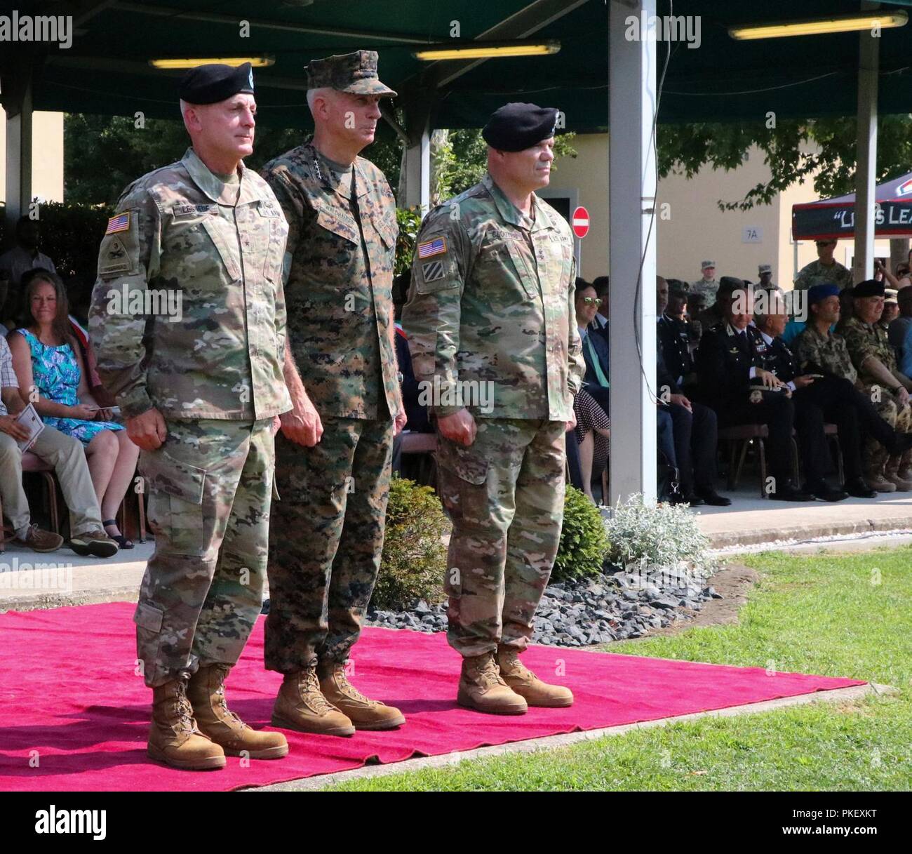Brig. Gen. Eugene J. LeBoeuf, left, the outgoing U.S. Army Africa acting commanding general; Marine Gen. Thomas D. Waldhauser, center, the U.S. Africa Command commanding general; and Maj. Gen. Roger L. Cloutier, the incoming U.S. Army Africa commanding general, prepare for the passing of the guidon during the USARAF change of command ceremony, held at Caserma Ederle in Vicenza, Italy, Aug. 2, 2018. Stock Photo
