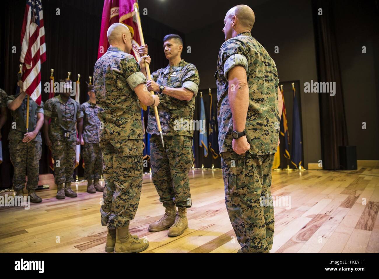 Brig. Gen. Mark Hashimoto, center, incoming commander of Force Headquarters Group, receives the colors from Maj. Gen. Michael F. Fahey, left, outgoing commander of FHG, during the change of command ceremony at the Federal City Auditorium, New Orleans, Aug. 3, 2018. While addressing the attendees, Fahey expressed his total confidence in Hashimoto as the new commander. Stock Photo