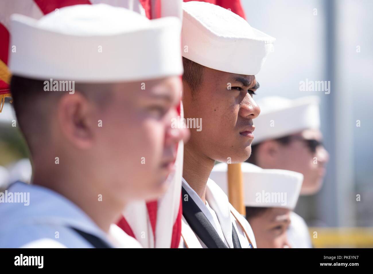 PEARL HARBOR (August 3, 2018) - The color guard displays the U.S. national ensign and the Hawaii state flag during the change of command ceremony for Los Angles-class fast-attack submarine USS Columbia (SSN 771) on the historic submarine piers at Joint Base Pearl Harbor-Hickam, August 3. Cmdr. Tyler Forrest relieved Cmdr. Dave Edgerton as Columbia’s commanding officer. Stock Photo