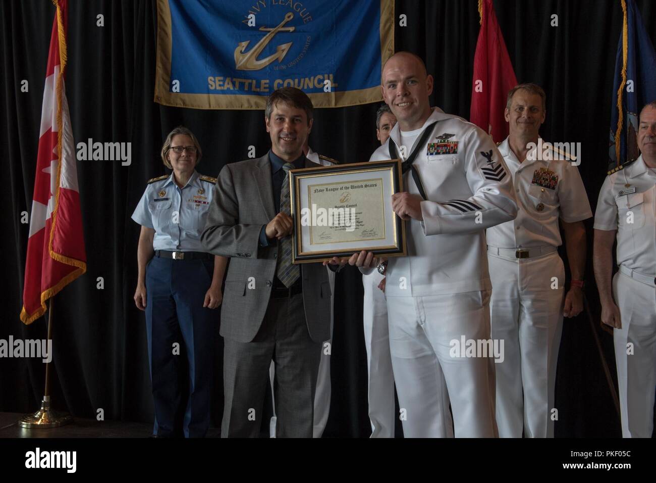 SEATTLE (Aug. 3, 2018) Hospital Corpsman 1st Class Thomas Geisinger is awarded Naval Hospital Bremerton Sailor of the Year during a Seattle Navy League Sea Services Luncheon as part of Seattle’s Seafair Fleet Week. Seafair Fleet Week is an annual celebration of the sea services wherein Sailors, Marines and Coast Guard members from visiting U.S. Navy and Coast Guard ships and ships from Canada make the city a port of call. Stock Photo
