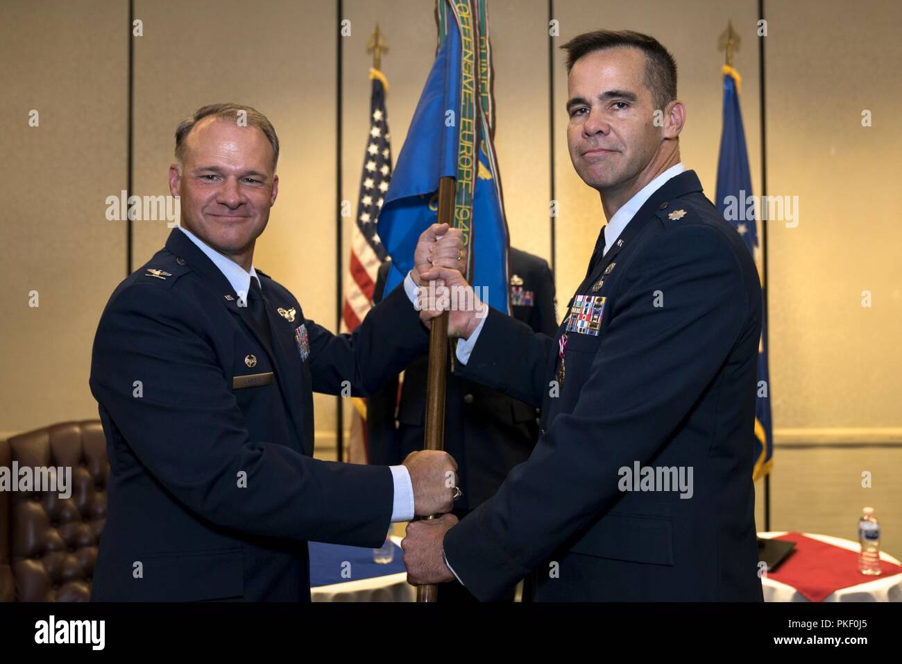 Col. Stephen Lanier, left, 315th Operations Group commander, receives the 4th Combat Camera Squadron guidon from Lt. Col. Hamilton Underwood, 4th CTCS commander, during a change of command ceremony Aug. 3, 2018, at Joint Base Charleston, S.C. The 4th CTCS is the only Reserve combat camera unit and is a rapid response force, specializing in aerial documentation. Underwood joined the unit in March 2001 and served a variety of positions before taking command for the first time in 2014. Stock Photo