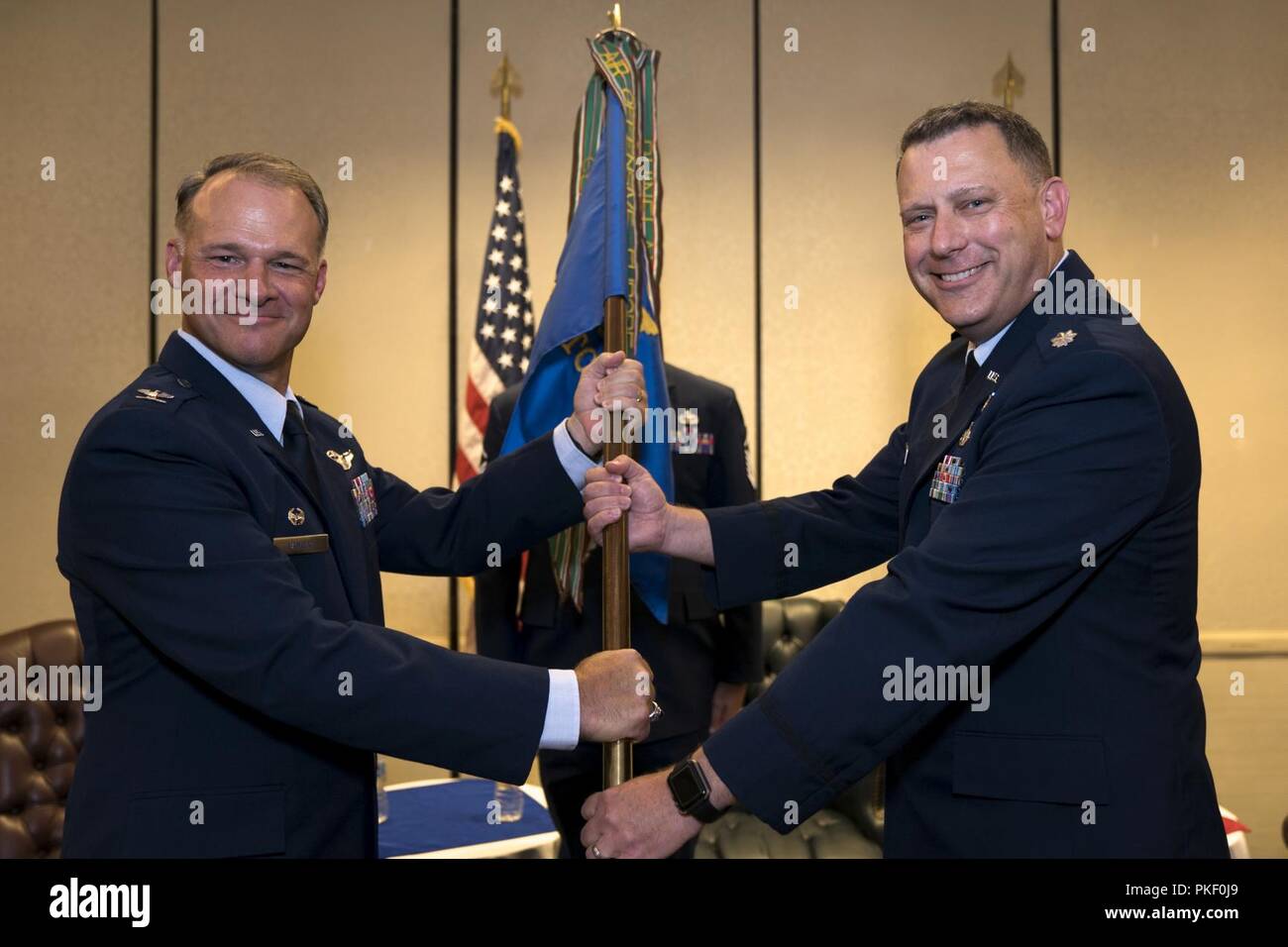 Lt. Col. Chad Gibson, right, receives the 4th Combat Camera Squadron guidon from Col. Stephen Lanier, 315th Operations Group commander, during a change of command ceremony Aug. 3, 2018, at Joint Base Charleston, S.C. By accepting the guidon, Gibson officially assumed command of the 4th CTCS. He previously served as the deputy director for Air Force Reserve Command public affairs at Robins Air Force Base, Ga. The 4th CTCS is the only Reserve combat camera unit and is a rapid response force, specializing in aerial documentation. Stock Photo