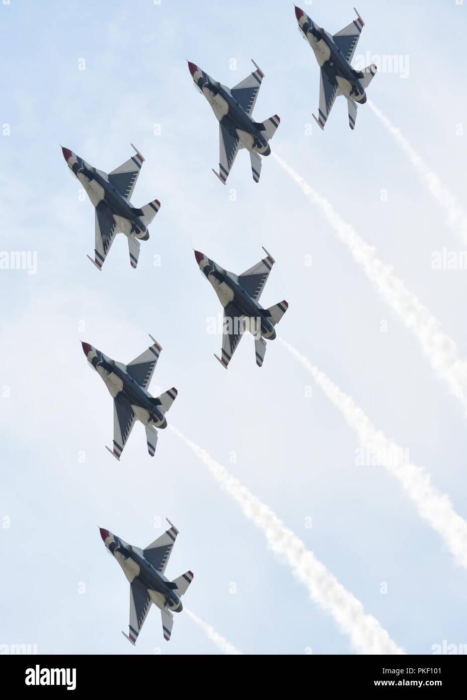 The U.S. Air Force Thunderbirds perform a delta formation during Northern Neighbors Day Air and Space Show at Minot Air Force Base, North Dakota, Aug. 4, 2018. The event featured aerial demonstrations by the U.S. Air Force Thunderbirds, Carlton Glider, B-25 Mitchell, T-33 Acemaker and more. Stock Photo