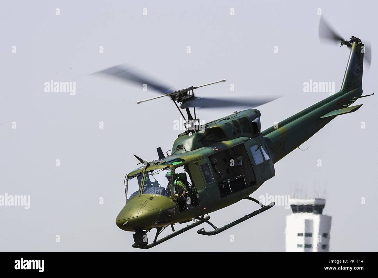 Members of the 54th Helicopter Squadron fly above the flightline during the Northern Neighbors Day Air and Space Show at Minot Air Force Base, North Dakota, Aug. 4, 2018. The event featured aerial demonstrations by the U.S. Air Force Thunderbirds, Carlton Glider, B-25 Mitchell, T-33 Acemaker and more. Stock Photo