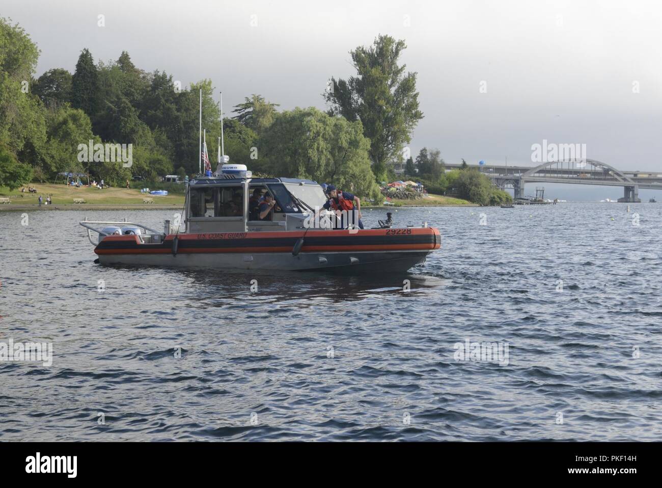 A boat crew member, aboard a 29-Foot Response Boat-Small II from Coast Guard Station Seattle, pulls a fender onto the boat as the crew heads out to conduct operations of Lake Washington in Seattle, Aug. 4, 2018.    The operations were part of a collaborative effort between the Coast Guard, local agency partners and Seafair staff to ensure safety on the water during the 69th annual Seafair Weekend Festival.    U.S. Coast Guard Stock Photo
