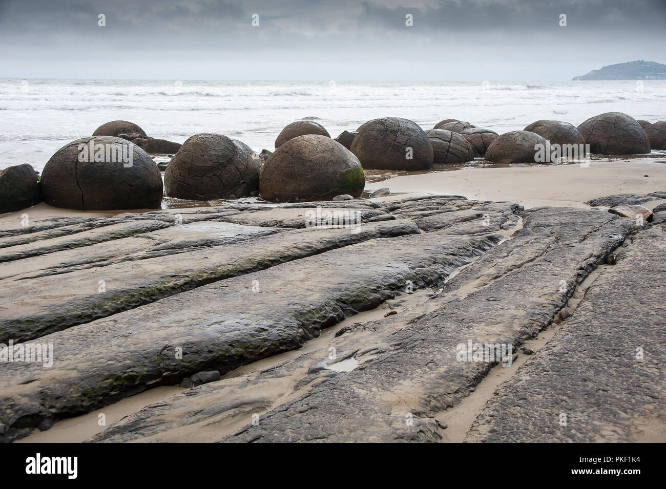 A 60 million year old giant ball shaped boulder on the beach at Moeraki  South Island New Zealand Stock Photo - Alamy