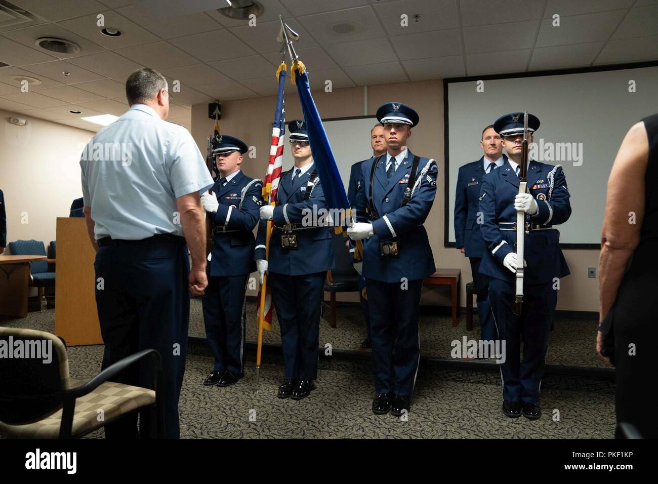 Honor guard members hold position at present arms during the 315th Aeromedical Evacuation Squadron assumption of command ceremony Aug. 5, 2018, at the Yonkie Auditorium at Joint Base Charleston, S.C. Lt. Col. David Bailey assumed command of the squadron after his tenure as interim commander. Stock Photo