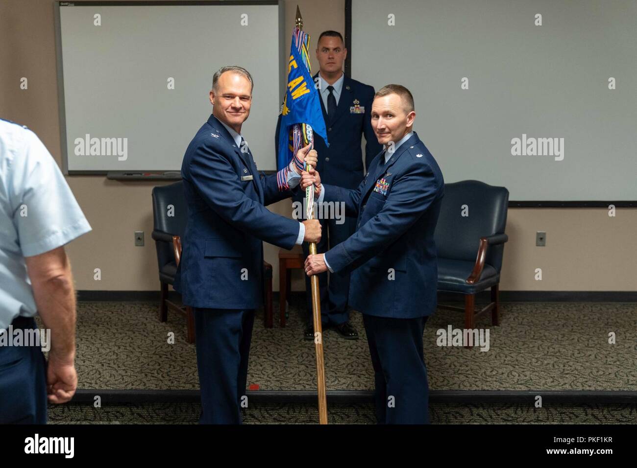 Lt. Col. David Bailey (right) accepts the 315th Aerospace Evacuation Squadron guidon from 315th Operations Group Commander Col. Stephen Lanier (left) during the 315th AES assumption of command ceremony Aug. 5, 2018, at the Yonkie Auditorium at Joint Base Charleston, S.C. Bailey assumed command of the squadron after his tenure as interim commander. Stock Photo