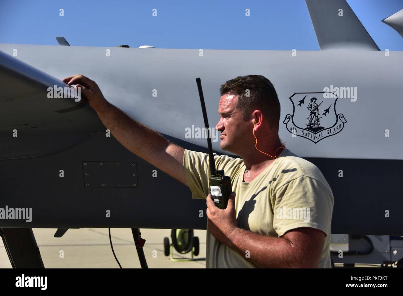 Members of the 163d Aircraft Maintenance Squadron,163d Attack Wing, California Air National Guard, conduct a preflight check on the wing's MQ-9 Reaper remotely piloted aircraft before a fire support mission, Aug. 1, 2018, at March Air Reserve Base, California. The wing is supporting state agencies who are battling numerous wildfires in Northern California, including the Carr Fire and Mendocino Complex Fire. Stock Photo