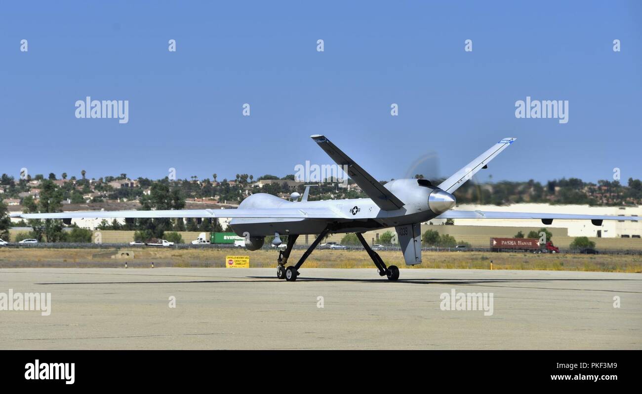 An MQ-9 Reaper remotely piloted aircraft from the 163d Attack Wing, California Air National Guard, taxis for takeoff during a fire support mission, Aug. 1, 2018, at March Air Reserve Base, California. The wing is supporting state agencies who are battling numerous wildfires in Northern California, including the Carr Fire and Mendocino Complex Fire. Stock Photo