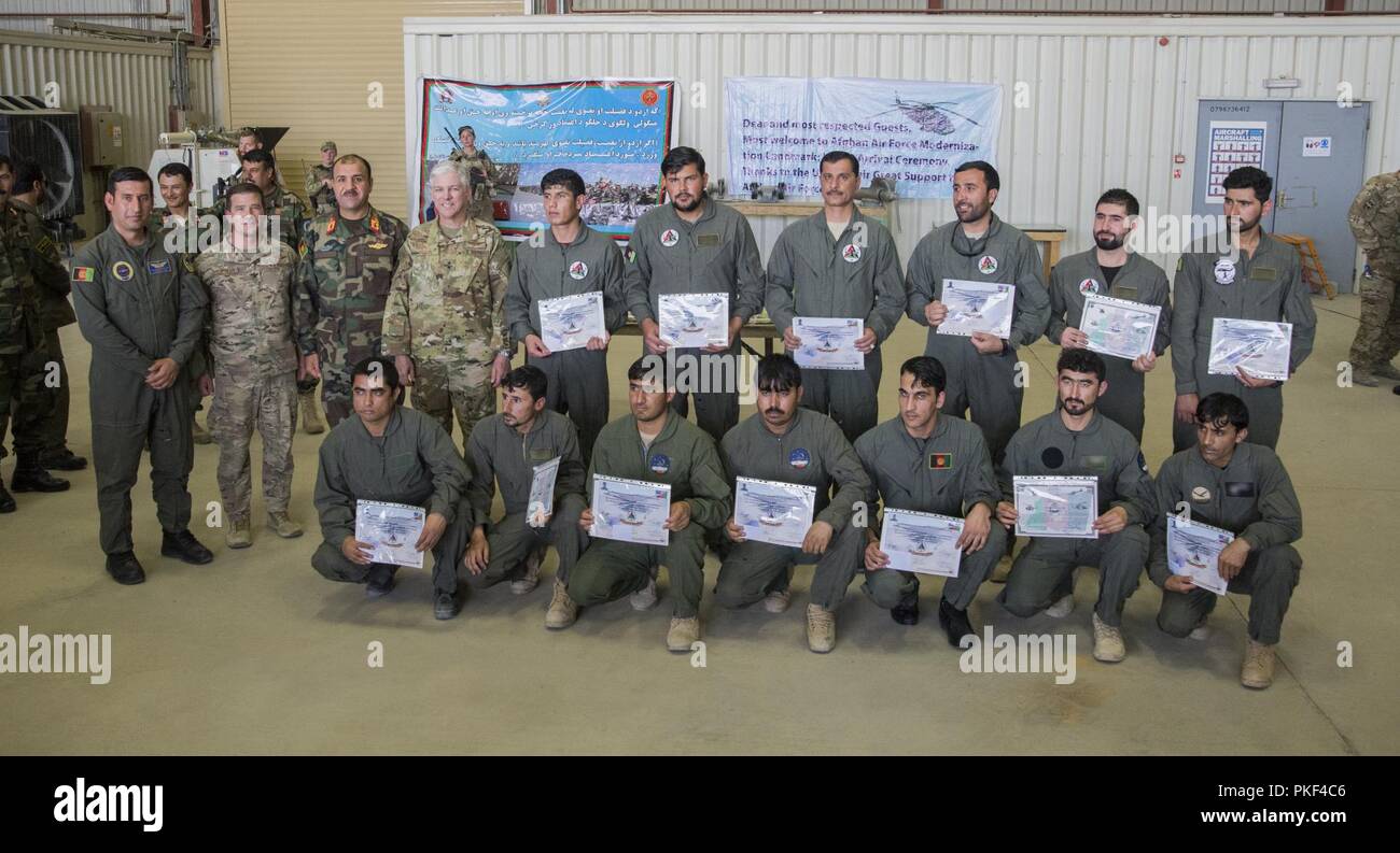 KANDAHAR AIRFIELD, Afghanistan (May 8, 2018) -- Graduates from UH-60 Mission Qualification Course display their certificates of training with Afghan Maj. Mahtabudin Safi, UH-60 Blackhawk Squadron commander, U.S. Air Force Col. Chris Goodyear, 738th Air Expeditionary Advisory Group commander, Afghan Maj. Gen. Abdul Raziq Sherzai, Kandahar Air Wing commander, and U.S. Air Force Maj. Gen. Barre Seguin, NATO Air Command Afghanistan and 9th Air and Space Expeditionary Task Force-Afghanistan commander, after the conclusion of a graduation August 6, 2018, Kandahar Airfield, Afghanistan. The graduates Stock Photo
