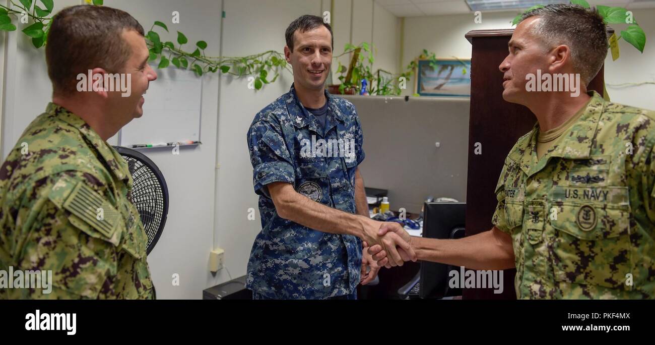Fla. (Aug. 7, 2018) Cryptologic Technician (Collection) 1st Class Cody Daigle, a training manager at the Center for Information Warfare Training (CIWT), receives news of his selection to the rank of chief petty officer from CIWT’s commanding officer, Capt. Nick Andrews (left) and CIWT Command Master Chief Mike Bates. Fifty-five staff members across the CIWT domain were selected for promotion. Stock Photo