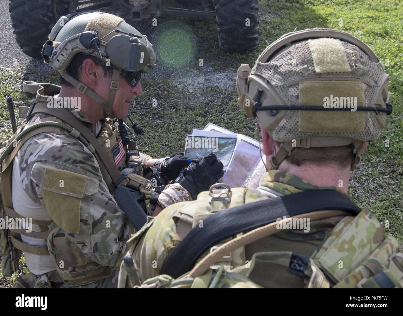 https://c8.alamy.com/comp/PKF5FW/senior-chief-explosive-ordnance-disposal-technician-luigi-mendoza-left-attached-to-explosive-ordnance-disposal-mobile-unit-eodmu-5-and-an-australian-army-soldier-read-a-map-during-the-unit-level-training-pyrocrab-at-naval-base-guam-august-6-2018-pyrocrab-is-a-biennial-unit-level-training-that-focuses-on-strengthening-the-relationships-and-enhancing-interoperability-between-the-us-navy-and-australian-forces-eodmu-5-is-assigned-to-commander-task-force-75-the-primary-expeditionary-task-force-responsible-for-the-planning-and-execution-of-coastal-riverine-operations-explosive-ordnanc-PKF5FW.jpg