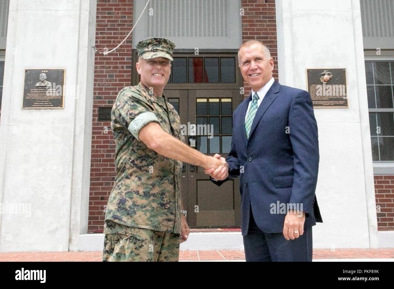 Col. Michael Scalise, deputy commander, Marine Corps Installations East, Marine Corps Base Camp Lejeune, welcomes Senate Armed Services Committee member Thom Tillis, senator of North Carolina, as he arrives at John A. Lejeune Hall on MCB Camp Lejeune, Aug. 6. Tillis also visited Naval Medical Center Camp Lejeune and participated in a round table discussion with senior enlisted Marines and spouses before touring on-base housing. “It is great to have Sen. Thom Tillis come to see what we do here at Camp Lejeune,” said Scalise. “When speaking to the spouses of our staff non-commissioned officers h Stock Photo