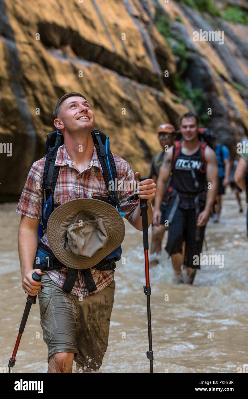 U.S. Marine Corps Sgt. Brehm Rhett, ground radio repairman, 1st Intelligence Battalion, I Marine Expeditionary Force-Information Group, admires the towering canyon walls during a hike at Zion National Park, Utah, Aug. 4, 2018. Single Marine Program trips are events only single active-duty service members and those dislocated from their spouses can participate in. Stock Photo